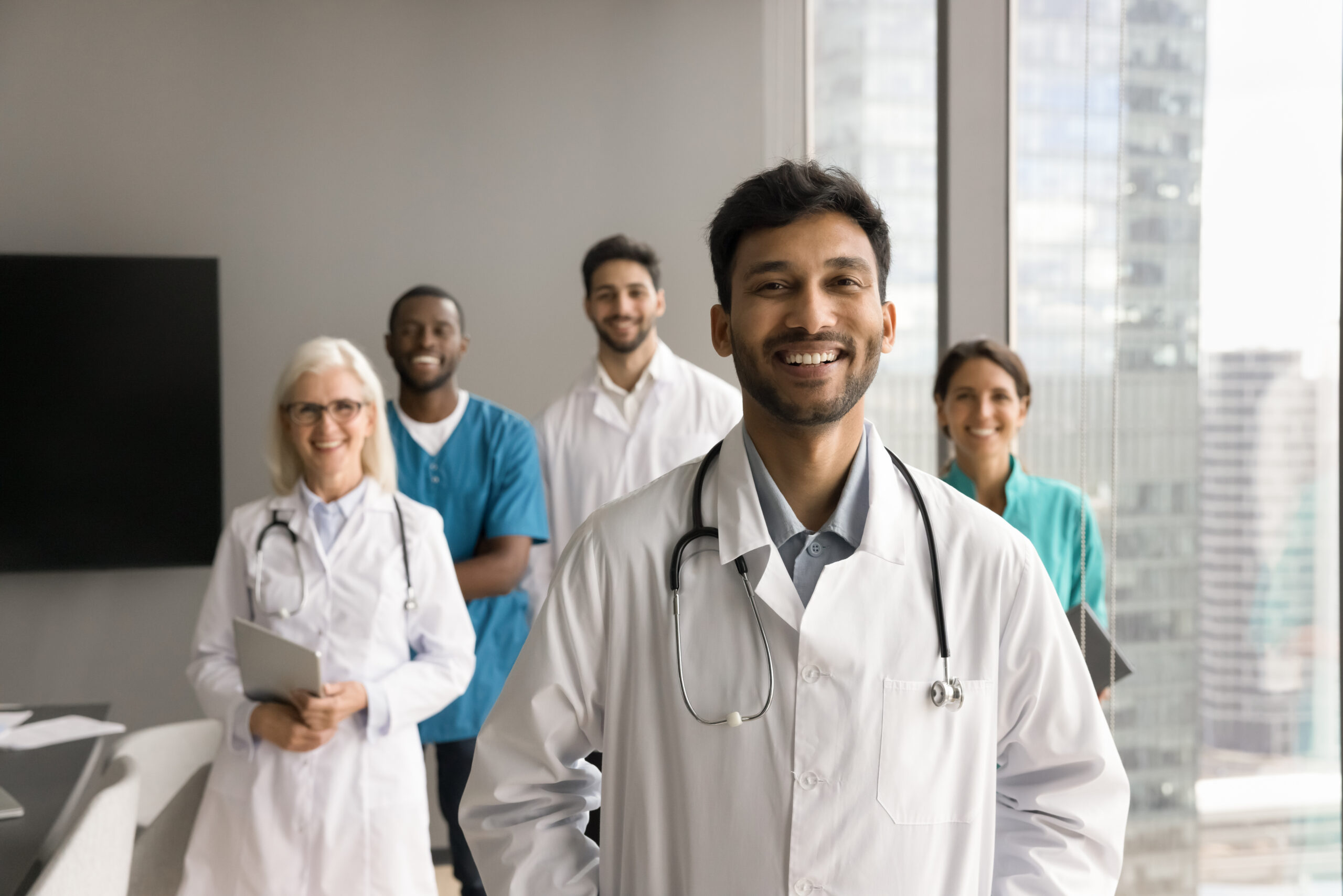 Cheerful Indian medical business leader man posing for professional portrait